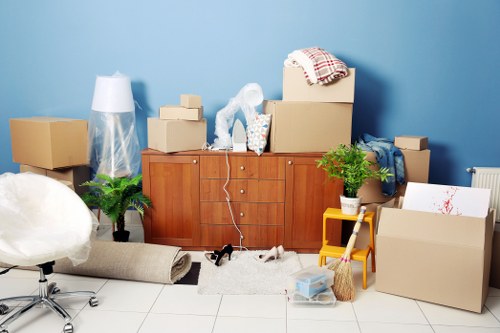 Packed moving boxes and furniture ready for transport in West Hampstead