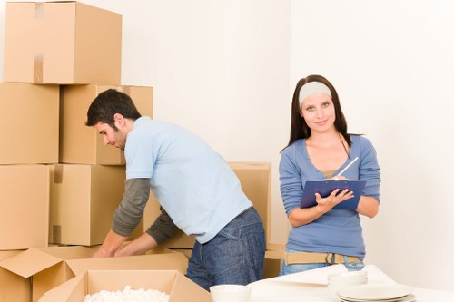 Professional movers handling furniture and boxes in a West Hampstead flat move